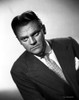 James Cagney Portrait Leaning Forward in Dark Grey Velvet Suit and White Polka Dot Necktie with White Background Photo Print - Item # VARCEL683255