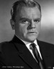 James Cagney Portrait Looking Serious in Black Velvet Suit and Black Silk Necktie with White Collar Shirt and Brushed Up Hair on Grey Background Photo Print - Item # VARCEL683270