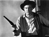 Film still of James Arness wearing a cowboy outfit and carrying a gun Photo Print - Item # VARCEL683555