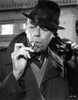 Film still of James Coburn smoking a cigarette and talking on the telephone Photo Print - Item # VARCEL683988