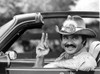 Film still of Burt Reynolds doing a peace sign in a car Photo Print - Item # VARCEL684190