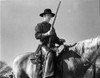 Film still of Tom Laughlin riding a horse carrying a gun Photo Print - Item # VARCEL684365