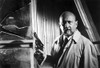 Film still of Donald Pleasence carrying a pistol Photo Print - Item # VARCEL684702