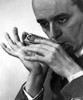 Larry Adler playing a harmonica Photo Print - Item # VARCEL684916