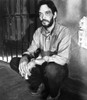 Raul Julia crouching in a prison Photo Print - Item # VARCEL684969