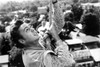 Robert Downey Jr climbing a rope in Air America Photo Print - Item # VARCEL685068