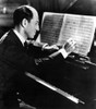 George Gershwin writing at his piano Photo Print - Item # VARCEL685173