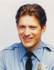 Costas Mandylor smiling in Police Outfit Photo Print - Item # VARCEL685369