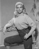 Jayne Mansfield Posed in White Tweed Long Sleeve Round Neck Shirt and High Waist Black Pants with Right Arm Rest on the Wood Fence Photo Print - Item # VARCEL685395