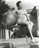 Ann Miller sitting on the Jumping Board Holding a Ball in a Classic Portrait Photo Print - Item # VARCEL685924