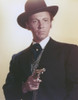 Cameron Mitchell Holding Pistol in Tuxedo Photo Print - Item # VARCEL686038