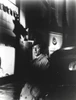 Film still featuring Robert Mitchum leaning on a car Photo Print