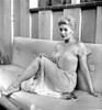 Kim Novak Siting on Bench in White Gown Photo Print - Item # VARCEL686539