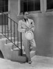 George Raft Leaning on Stair Railing in Formal Outfit With Hat Portrait Photo Print - Item # VARCEL687003