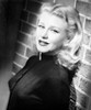 Ginger Rogers leaning on a brick wall Photo Print