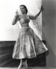 Jane Russell Posed in White Floral Silk Strap Dress with Left Hand Touching the Wall while Looking to the Right Photo Print - Item # VARCEL687481