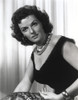 Jane Russell Portrait in Black Silk Deep V-Neck Dress and Pearl Necklace with Hoop Earrings Photo Print - Item # VARCEL687486