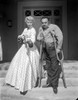 Violent Men Woman Holding a Rifle with Man on Crutches Photo Print - Item # VARCEL687693