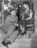Rose Tattoo Woman Seated on Chair with Man Seated on Floor Photo Print - Item # VARCEL687699