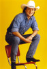 Mark Chesnutt sitting on Chair, wearing Cowboy Outfit with Black Leather Shoes Photo Print - Item # VARCEL688242