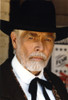 James Coburn Portrait in Black Suit and White Shirt with Black Collar Ribbon and Brimmed Hat Photo Print - Item # VARCEL688477