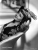 Claudette Colbert sitting in Floral Dress with Two Hands on Head Photo Print - Item # VARCEL688503