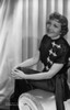 Claudette Colbert sitting on Couch, wearing Black Dress Photo Print - Item # VARCEL688513