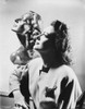 Joan Crawford posing beside a sculpture Photo Print - Item # VARCEL688746