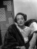Joan Crawford Looking Away From the Camera while Leaning on a Chair in Classic Photo Print - Item # VARCEL688770