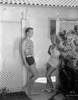 Joan Crawford Talking to a Guy Near the Gate in a Classic Portrait Photo Print - Item # VARCEL688803