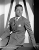 Cary Grant in a suit sitting down with a pocket chief H Photo Print - Item # VARCEL696058