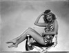 Joyce Compton sitting on a Beach Chair wearing a One Piece Bikini in a Classic Portrait Photo Print - Item # VARCEL696291