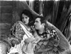 Bebe Daniels Leaning Back on the Wall with a Man in White Floral Dress Photo Print - Item # VARCEL696700