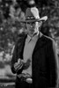 Clint Eastwood Looking Serious in Black Coat with Pistol in His Pants Photo Print - Item # VARCEL696733