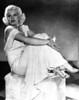 Jean Harlow Posed in White V-Neck Linen Ruffled Strap Dress with Knees Bent and Hands Together Photo Print - Item # VARCEL696941