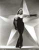 Anita Ekberg Pointing Her Left Hand with a Huge Star in Background in Classic Portrait Photo Print - Item # VARCEL696929