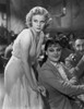 Jean Harlow Scene from a Film standing while Leaning Forward in White Silk Dress Photo Print - Item # VARCEL697251
