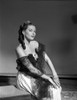 Yvonne Decarlo sitting in Black Strapless Dress with Net Dress Photo Print - Item # VARCEL697253