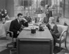 Jean Harlow Scene from a Film sitting In front of the Table in Black Long Sleeve Dress with Right Arm on the Table Photo Print - Item # VARCEL697275