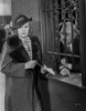 Jean Harlow Scene from a Film Posed in Black Tweed Linen Coat with Black Velvet Collar and Checkered White Scarf Photo Print - Item # VARCEL697284