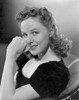 Susan Hayward sitting and Leaning on a Black Dress Photo Print - Item # VARCEL697659