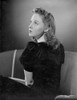 Susan Hayward sitting and Looking Up on Couch in Black Dress Photo Print - Item # VARCEL697723