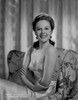Susan Hayward sitting on a Printed Couch in Silk Dress Photo Print - Item # VARCEL697756