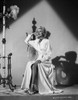 Rita Hayworth Leaning and sitting in a Looking Up Pose Photo Print - Item # VARCEL697940
