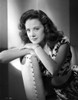 Carol Forman Posed in a Printed Dress and Hands and Chin Leaning on Head Rest of Chair Photo Print - Item # VARCEL698606
