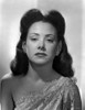 Carol Forman wearing an Embroidered Dress with Earrings Photo Print - Item # VARCEL698615