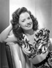 Carol Forman wearing a Printed Dress with Head Leaning on Hand Photo Print - Item # VARCEL698672