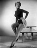 Mona Freeman on a Midriff Turtle Neck with Hands on Waist sitting Portrait Photo Print - Item # VARCEL698767