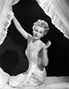 Eva Gabor on Silk Dress sitting on Bed Photo Print - Item # VARCEL698873