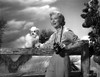 Greer Garson wearing Silk Top Holding a Camera and a Dog Photo Print - Item # VARCEL698929